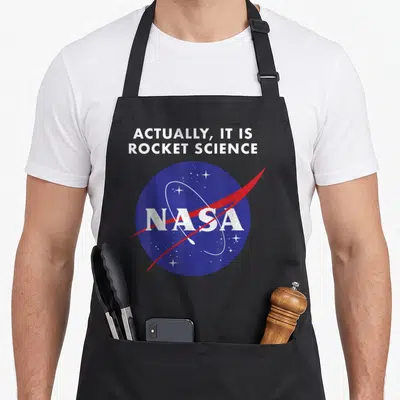 Actually nasa apron - Distressed blue NASA logo with white stars and red swoosh under sarcastic text — shown on a black cotton canvas apron against a white background