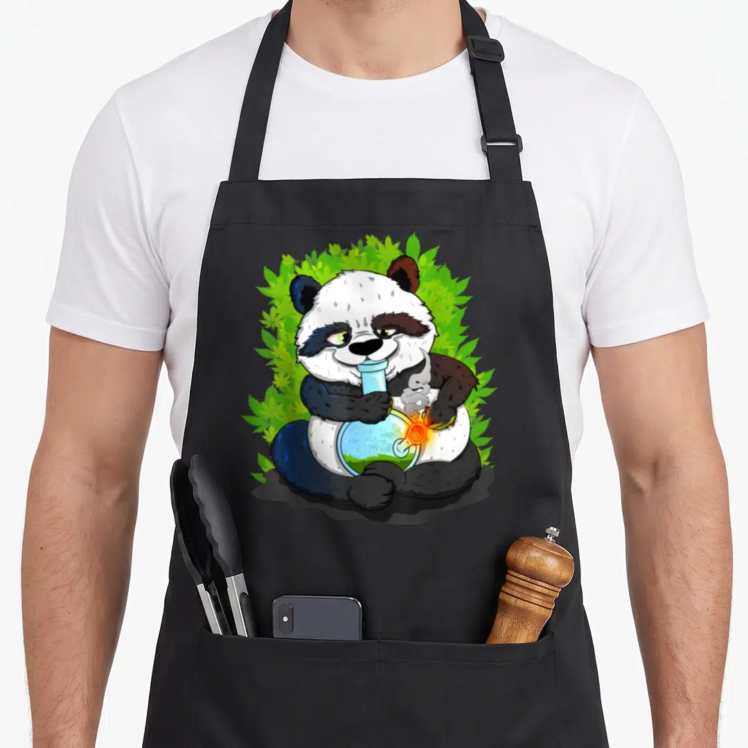 Bong smoking apron - Cartoon panda holding blue bong surrounded by green cannabis leaves on black fabric — shown on a black cotton canvas apron against a white background