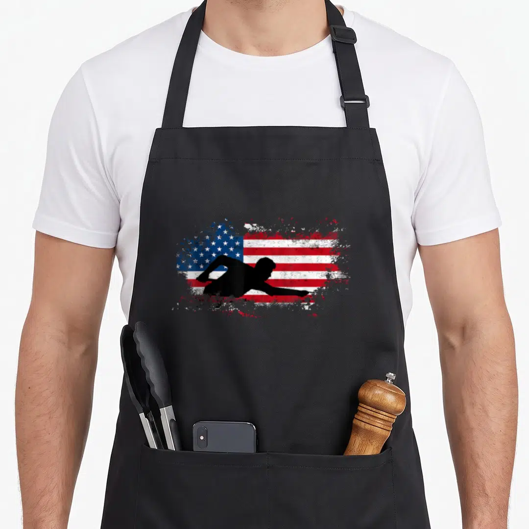 Sport billiards apron - Black diving athlete silhouette over distressed red white and blue USA flag — shown on a black cotton canvas apron against a white background