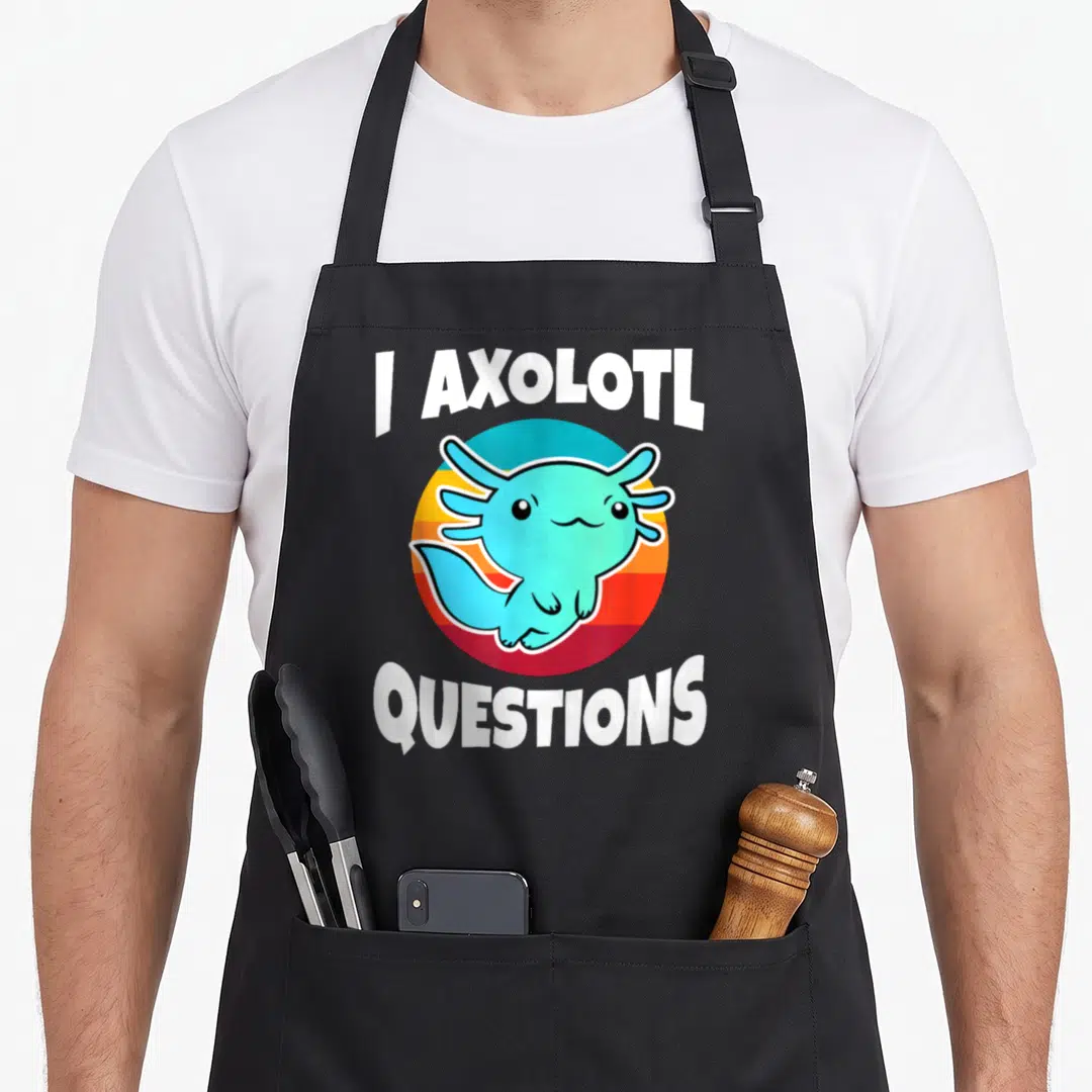 Axolotl i love star apron - Cartoon teal axolotl inside orange and red striped circle with white text — shown on a black cotton canvas apron against a white background