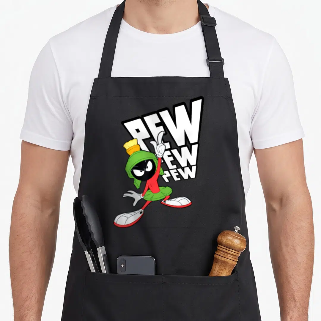 Marvin pew apron - Marvin the Martian character standing in front of three stacked slanted PEW words in white, green — shown on a black cotton canvas apron against a white background