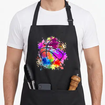 Baller basketball apron - White basketball outline over purple blue red yellow green watercolor paint splatter — shown on a black cotton canvas apron against a white background