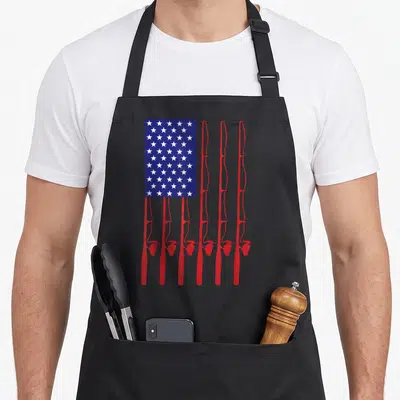 Flag fishing apron - Seven red fishing rods stand vertically under a blue rectangle filled with white stars — shown on a black cotton canvas apron against a white background
