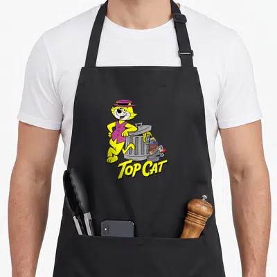 Garbage cat apron - Yellow cartoon cat in purple hat leaning on grey trash can with TOP CAT text — shown on a black cotton canvas apron against a white background