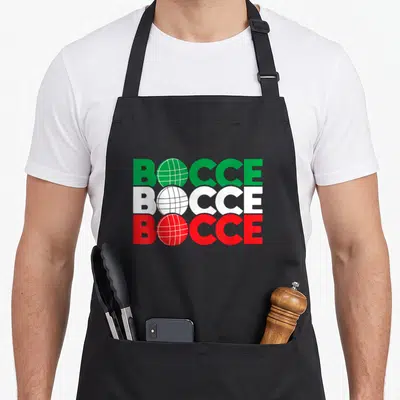 Bocce game aprons - Stacked BOCCE text with ball icons in green white and red — shown on a black cotton canvas apron against a white background