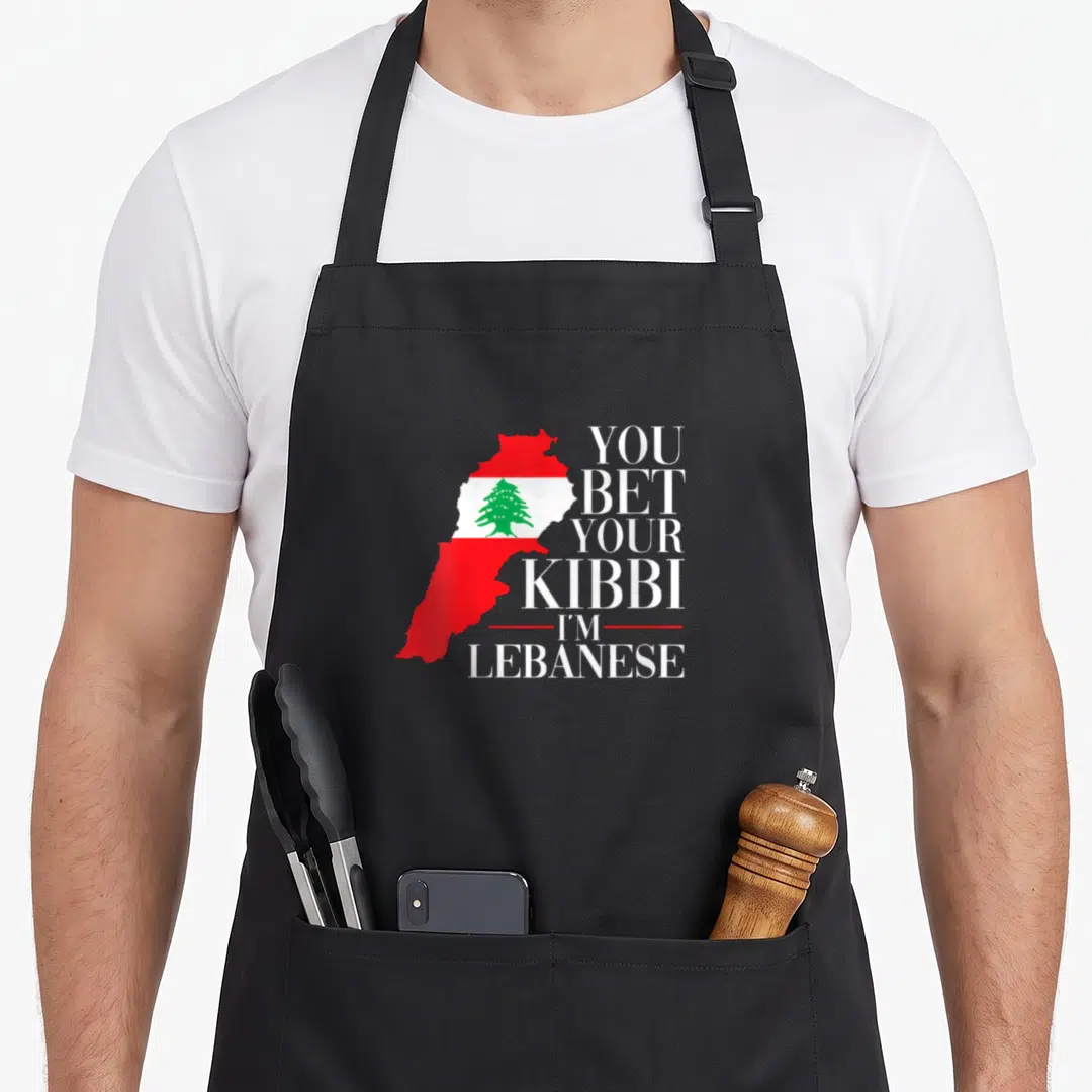 Bet lebanon apron - Lebanon map filled with red white green flag next to stacked white text — shown on a black cotton canvas apron against a white background
