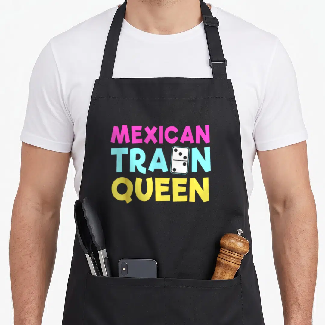 Train mexican apron - Stacked pink blue and yellow text reading MEXICAN TRAIN QUEEN with a white domino tile replacing — shown on a black cotton canvas apron against a white background