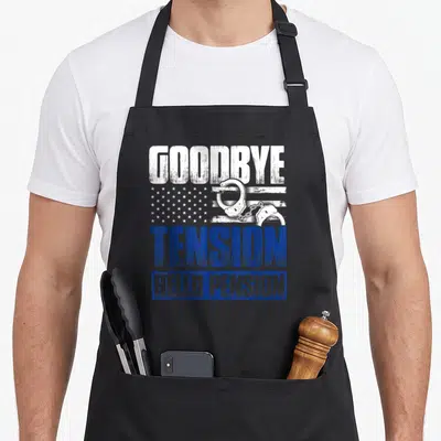 Retired policeman police apron - Goodbye Tension Hello Pension text with distressed flag and white handcuffs in blue — shown on a black cotton canvas apron against a white background