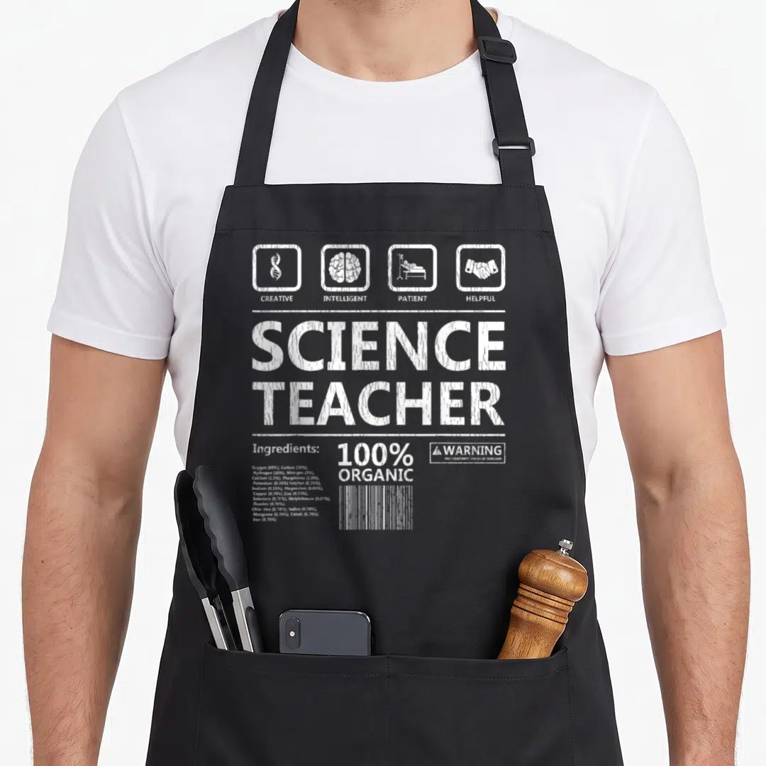 Intelegent creative apron - White typography design reading Science Teacher with ingredient list and sarcasm warning — shown on a black cotton canvas apron against a white background