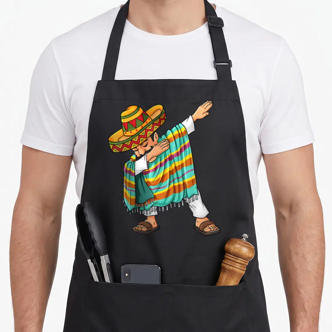 Mayo dabbing mexican apron - Cartoon man in striped poncho and sombrero performing a dab dance pose — shown on a black cotton canvas apron against a white background
