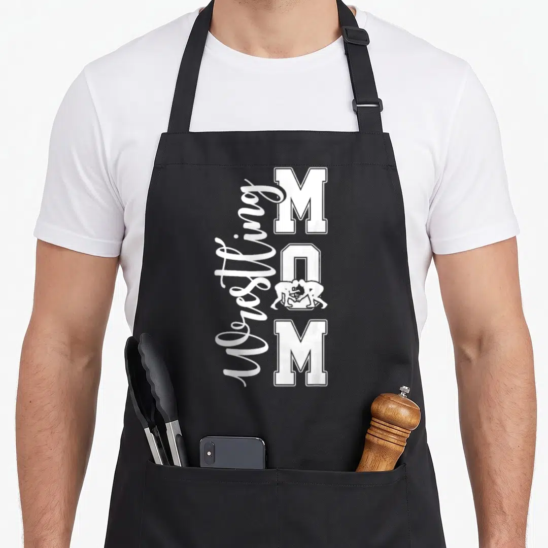Wrestling mother's day aprons - White Wrestling MOM text with wrestlers inside the letter O on an apron — shown on a black cotton canvas apron against a white background