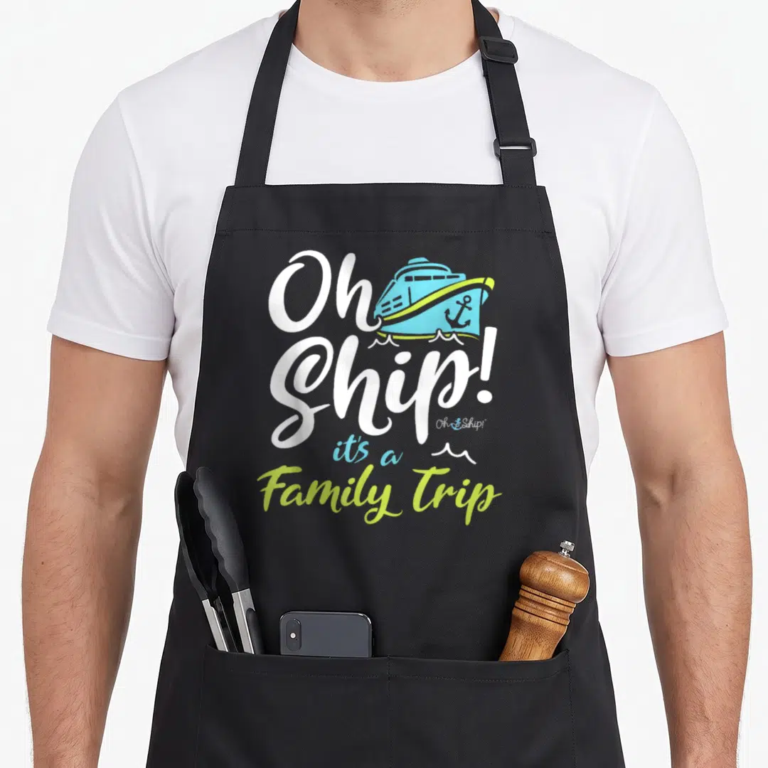 Ship trip family aprons - Oh Ship It's a Family Trip text with cartoon blue cruise ship and lime green waves — shown on a black cotton canvas apron against a white background