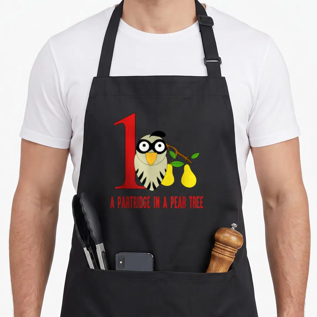Pear christmas tree apron - Cartoon partridge standing before red number one beside yellow pears on green branch — shown on a black cotton canvas apron against a white background
