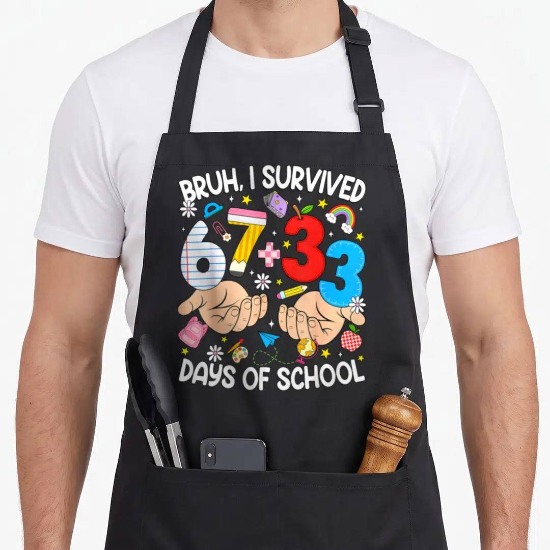 Bruh survived teacher apron - Cartoon hands holding 67 plus 33 days of school supplies with white text — shown on a black cotton canvas apron against a white background