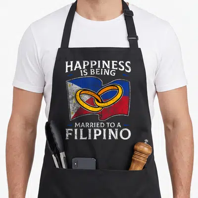 Philippine heritage aprons - Distressed Philippine flag with two interlocking gold rings and text HAPPINESS IS BEING — shown on a black cotton canvas apron against a white background