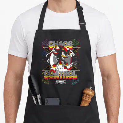 Shadow hedgehog fathers apron - Shadow the Hedgehog centered over X shape with Chaos Control text and six wireframe — shown on a black cotton canvas apron against a white background