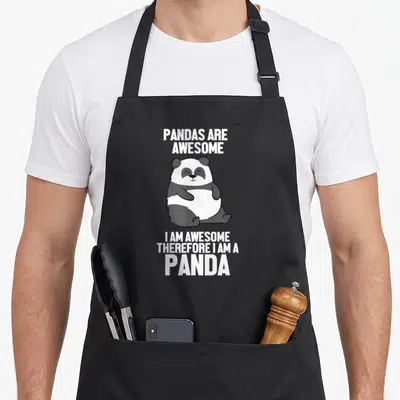 Pandas awesome therefore apron - Cartoon panda sitting between white text reading Pandas Are Awesome I Am Awesome — shown on a black cotton canvas apron against a white background