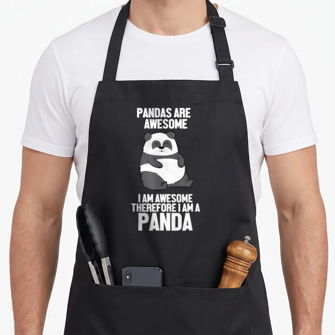 Pandas awesome therefore apron - Cartoon panda sitting between white text reading Pandas Are Awesome I Am Awesome — shown on a black cotton canvas apron against a white background