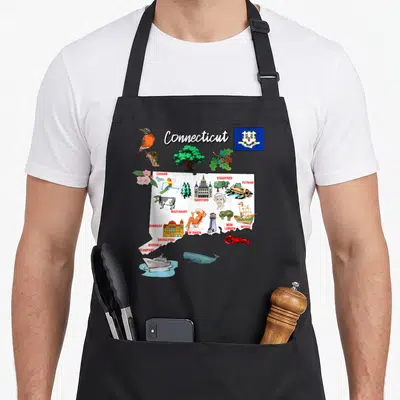 Illustrated connecticut apron - Cartoon map of Connecticut with city names, state flag, robin, lobster, and lighthouse — shown on a black cotton canvas apron against a white background