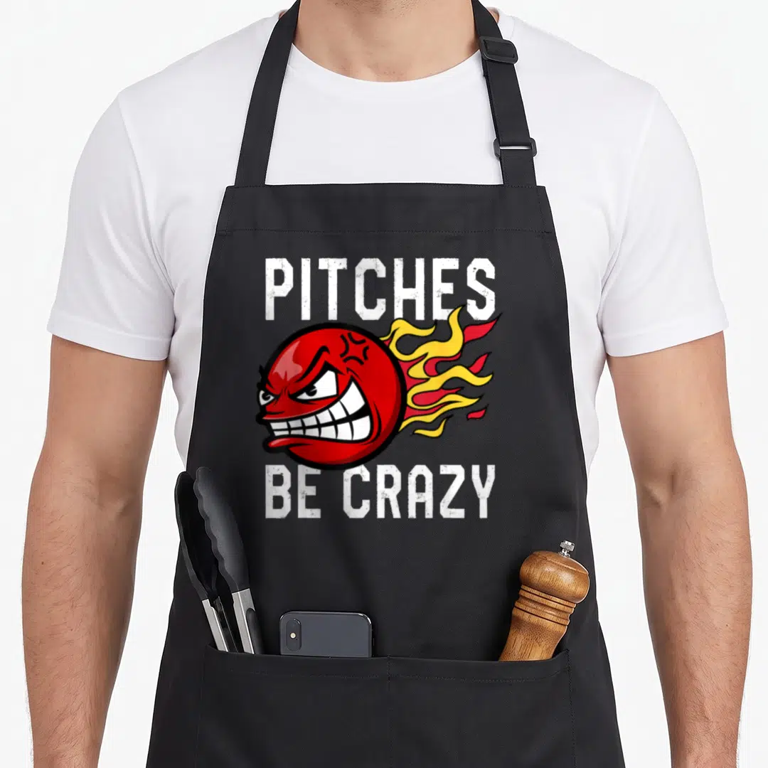 Pitch kickball apron - Flaming red angry baseball with PITCHES BE CRAZY text — shown on a black cotton canvas apron against a white background