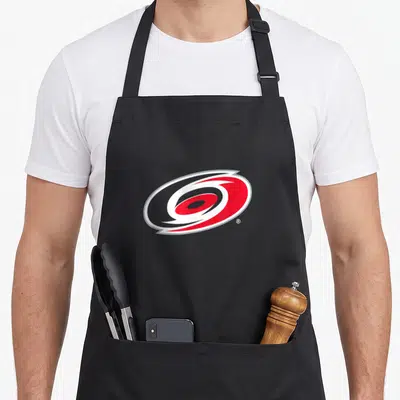 Icon hurricane apron - Stylized red and white oval swirl logo on grey background — shown on a black cotton canvas apron against a white background