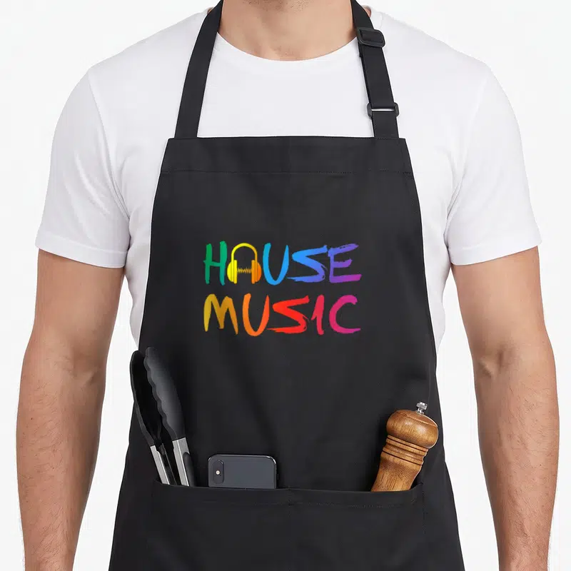 Music enchantments apron - Colorful HOUSE MUSIC text with yellow headphones replacing the O in two stacked lines — shown on a black cotton canvas apron against a white background