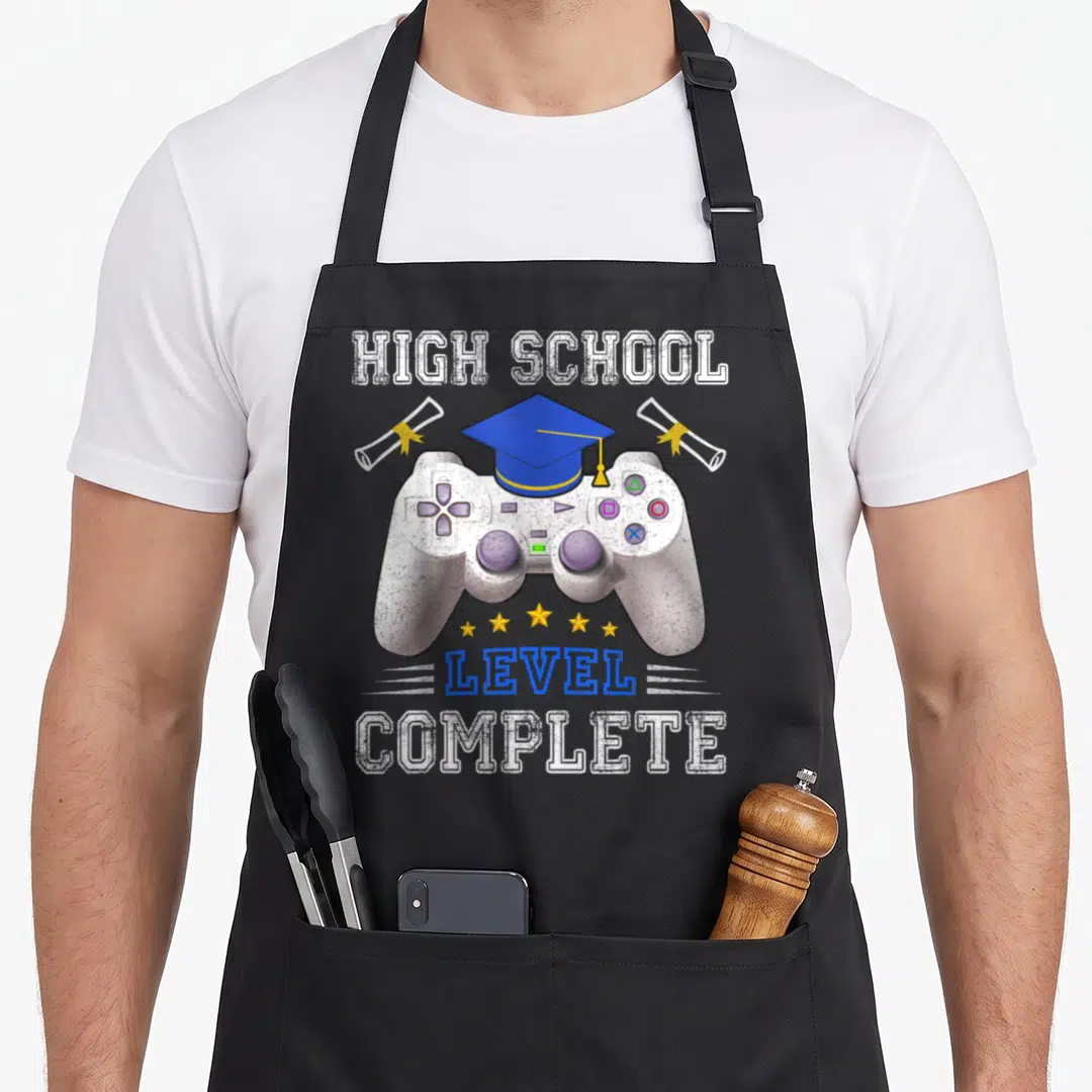Complete school graduation apron - Game controller with blue cap, yellow diplomas, five stars, HIGH SCHOOL LEVEL — shown on a black cotton canvas apron against a white background