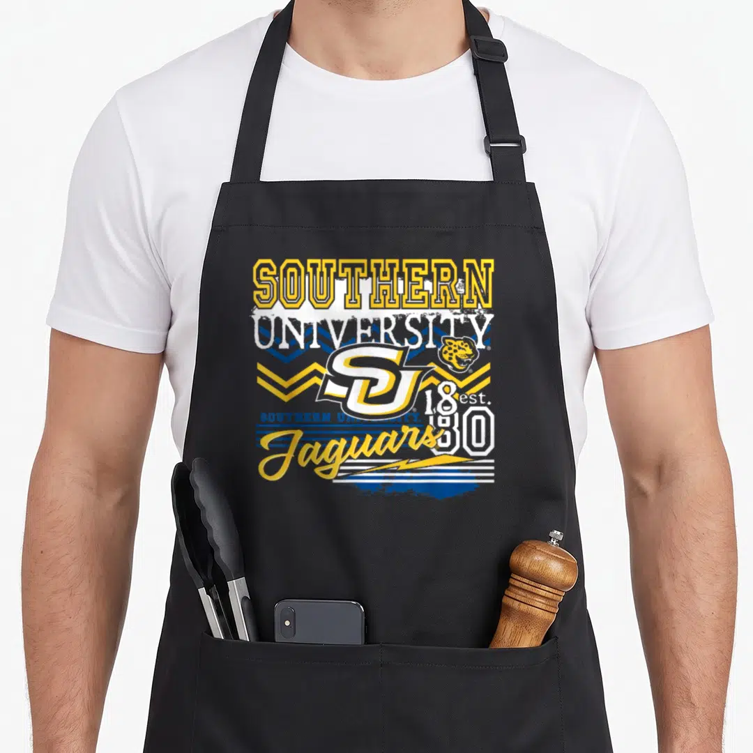 Hbcu southern aprons - Retro Southern University SU logo with jaguar head, yellow blue stripes, and est 1830 text — shown on a black cotton canvas apron against a white background