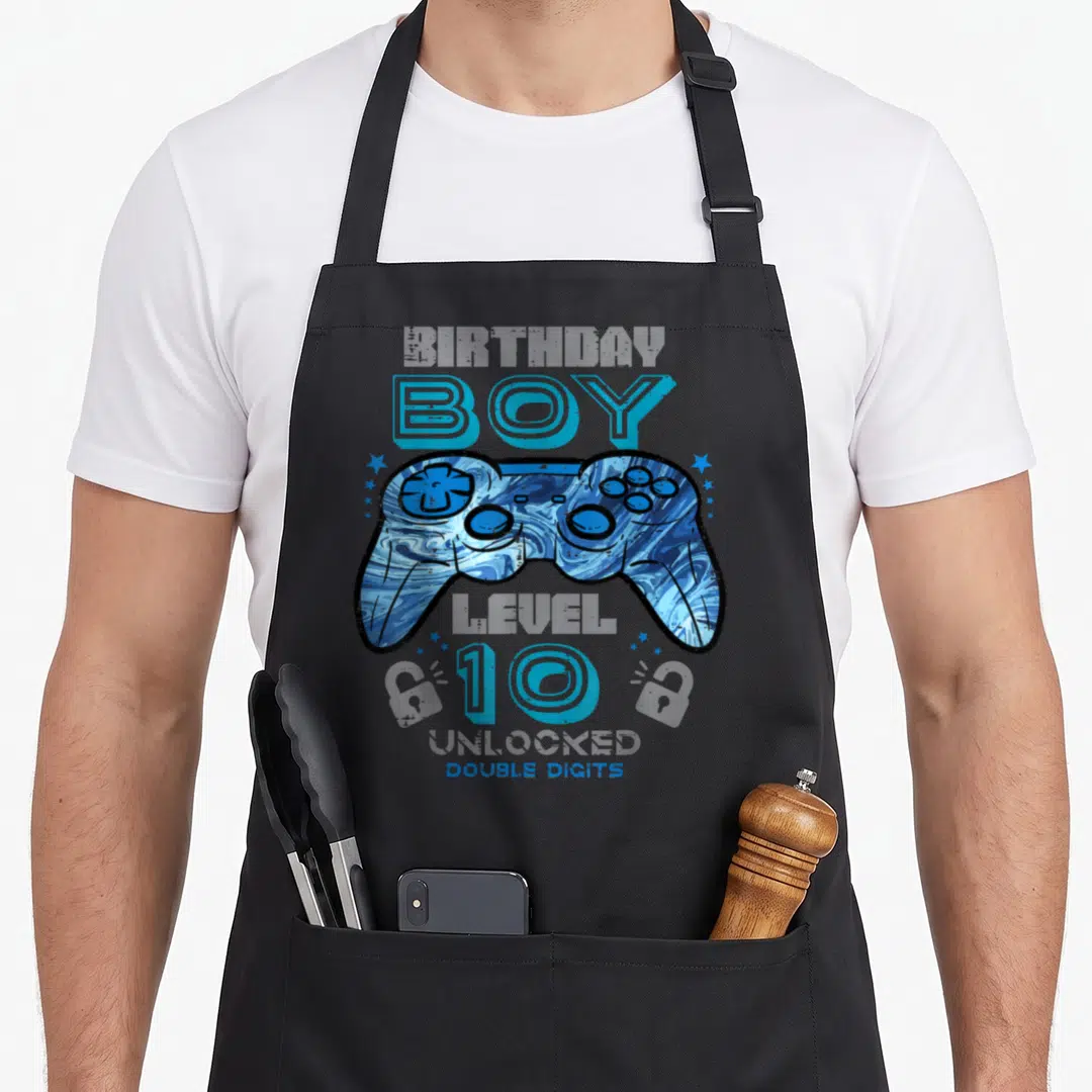 Unlocked double birthday apron - Blue marbled game controller with BOY 10 DOUBLE DIGITS text and stars — shown on a black cotton canvas apron against a white background