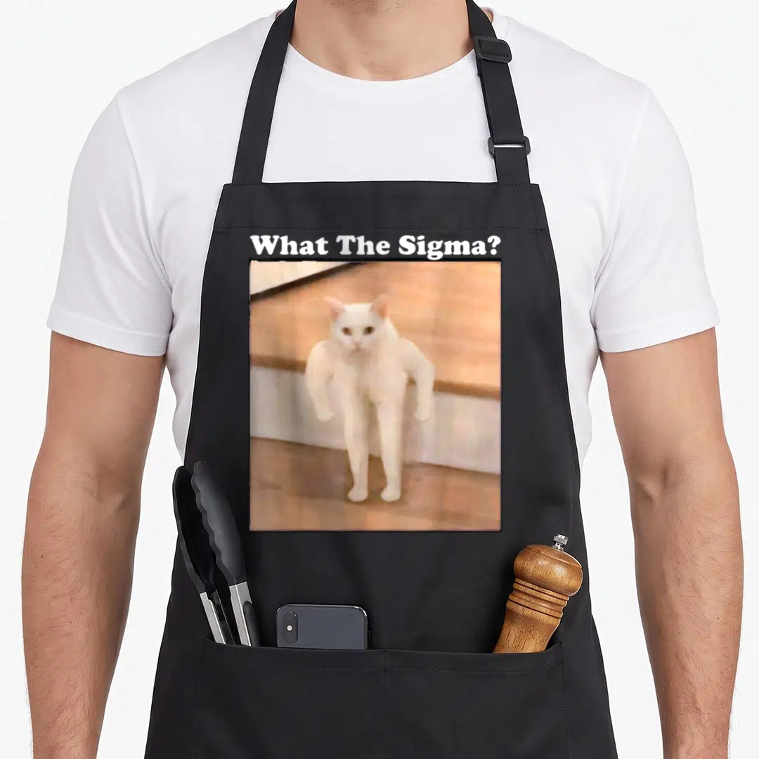 Sigma cat apron - What The Sigma text above muscular white cat photo — shown on a black cotton canvas apron against a white background