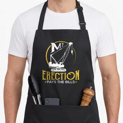 Operator crane apron - White crane graphic with MY ERECTION PAYS THE BILLS text — shown on a black cotton canvas apron against a white background
