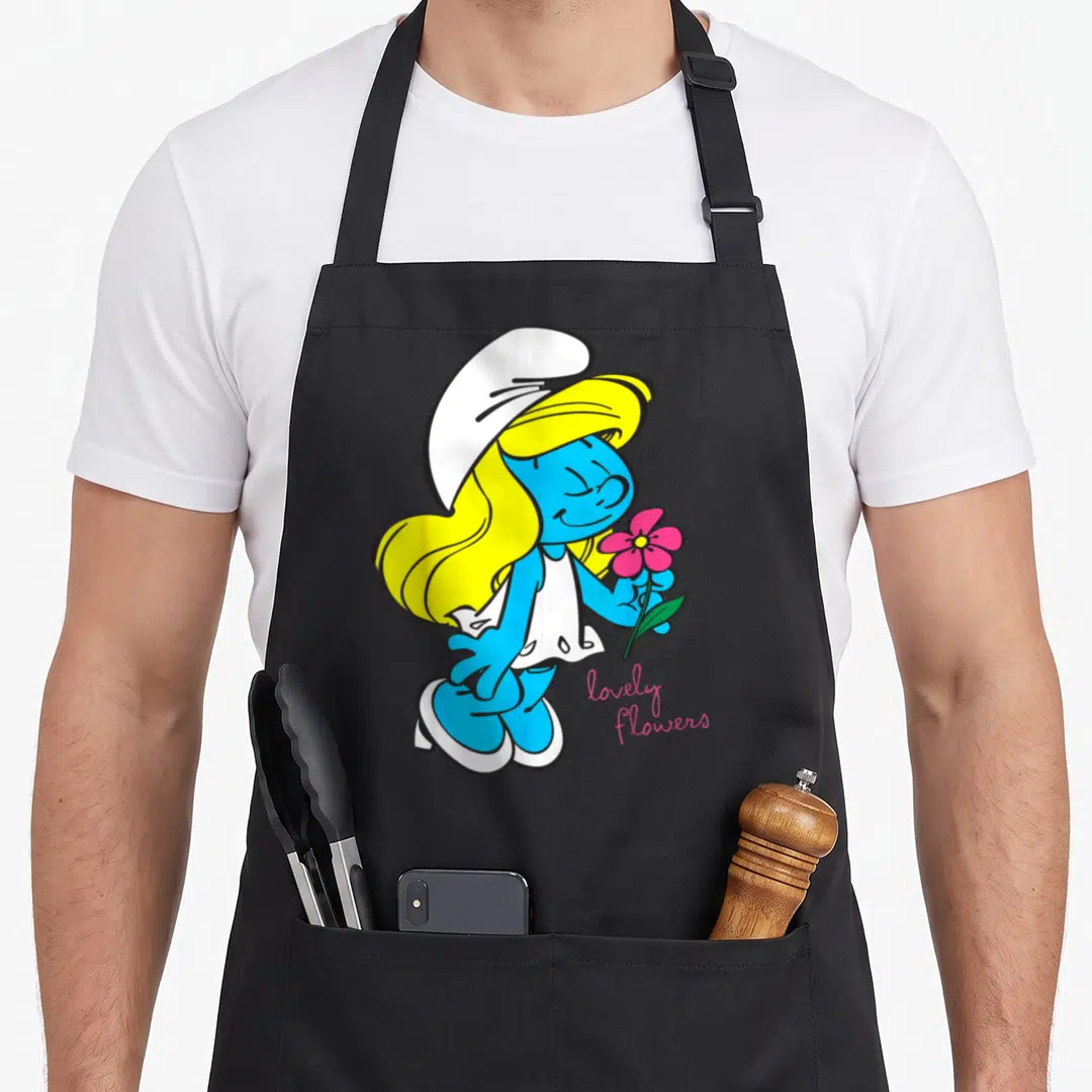 Smurfette character aprons - Smurfette holding pink flower with lovely flowers text in cartoon style — shown on a black cotton canvas apron against a white background