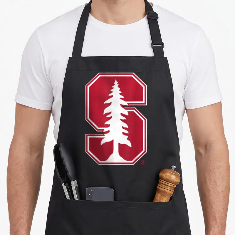 Icon cardinal apron - Red block S with white tree silhouette inside white border — shown on a black cotton canvas apron against a white background