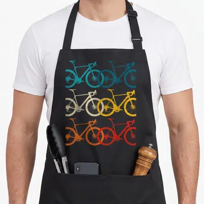 Bike road cycling apron - Six retro bicycles in teal blue beige yellow orange and red arranged in a grid — shown on a black cotton canvas apron against a white background