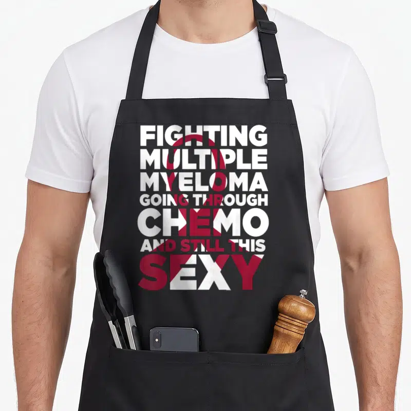 Multiple myeloma awareness ribbon apron - Stacked white and red text reading Fighting Multiple Myeloma Chemo Sexy — shown on a black cotton canvas apron against a white background