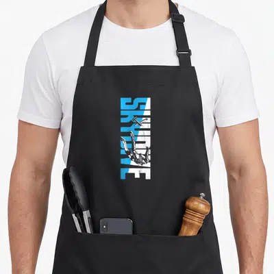Skydive freediving apron - Vertical SURVIVE text in blue and white with falling person and plane, distressed style — shown on a black cotton canvas apron against a white background