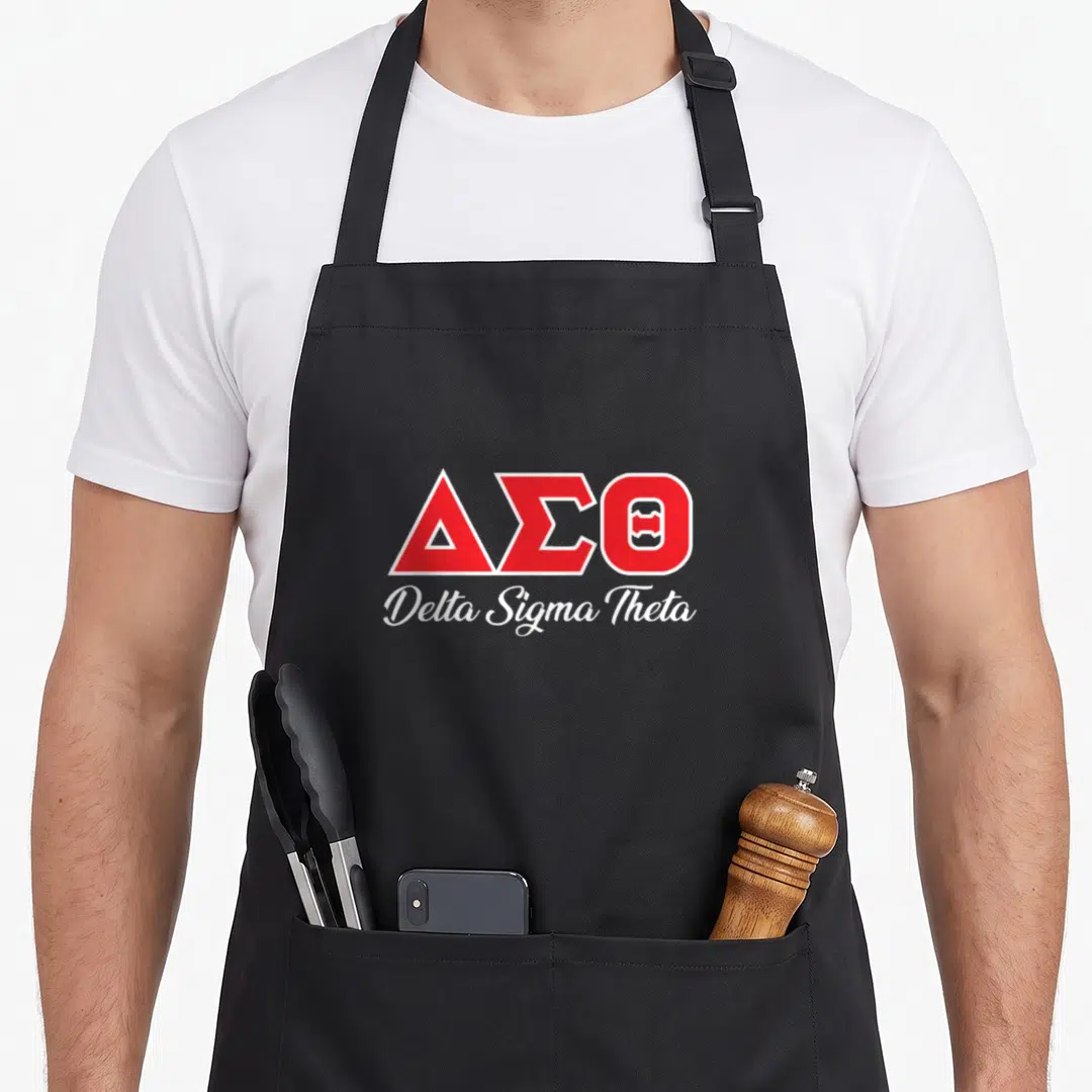 Theta paraphernalia sorority apron - Red Delta Sigma Theta Greek letters and white script on black bib — shown on a black cotton canvas apron against a white background