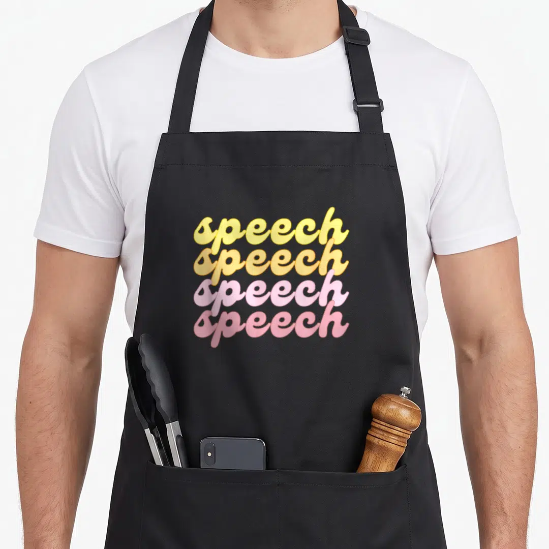 Summer spring apron - Stacked speech text in yellow orange and pink bubble lettering — shown on a black cotton canvas apron against a white background