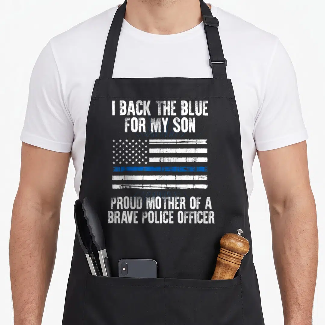 Police mom and son aprons - Distressed thin blue line flag with white text supporting a police officer son — shown on a black cotton canvas apron against a white background