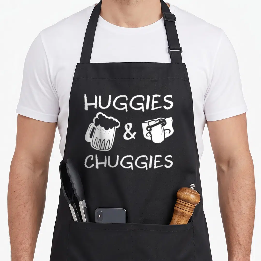 Diaper pregnancy by company apron - White line art of beer mug and diaper with Huggies Chuggies text — shown on a black cotton canvas apron against a white background