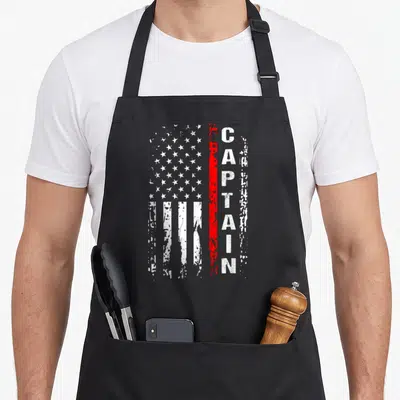 Captain firefighter apron - Distressed flag with white stars stripes and red line plus vertical CAPTAIN text — shown on a black cotton canvas apron against a white background