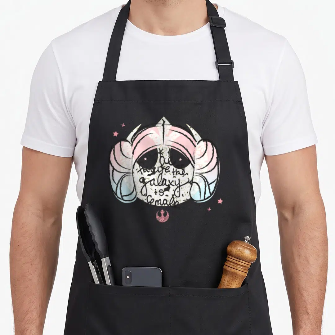 Cute princess apron - Cartoon Princess Leia hair with The future of the galaxy is female text and pink rebel symbol — shown on a black cotton canvas apron against a white background