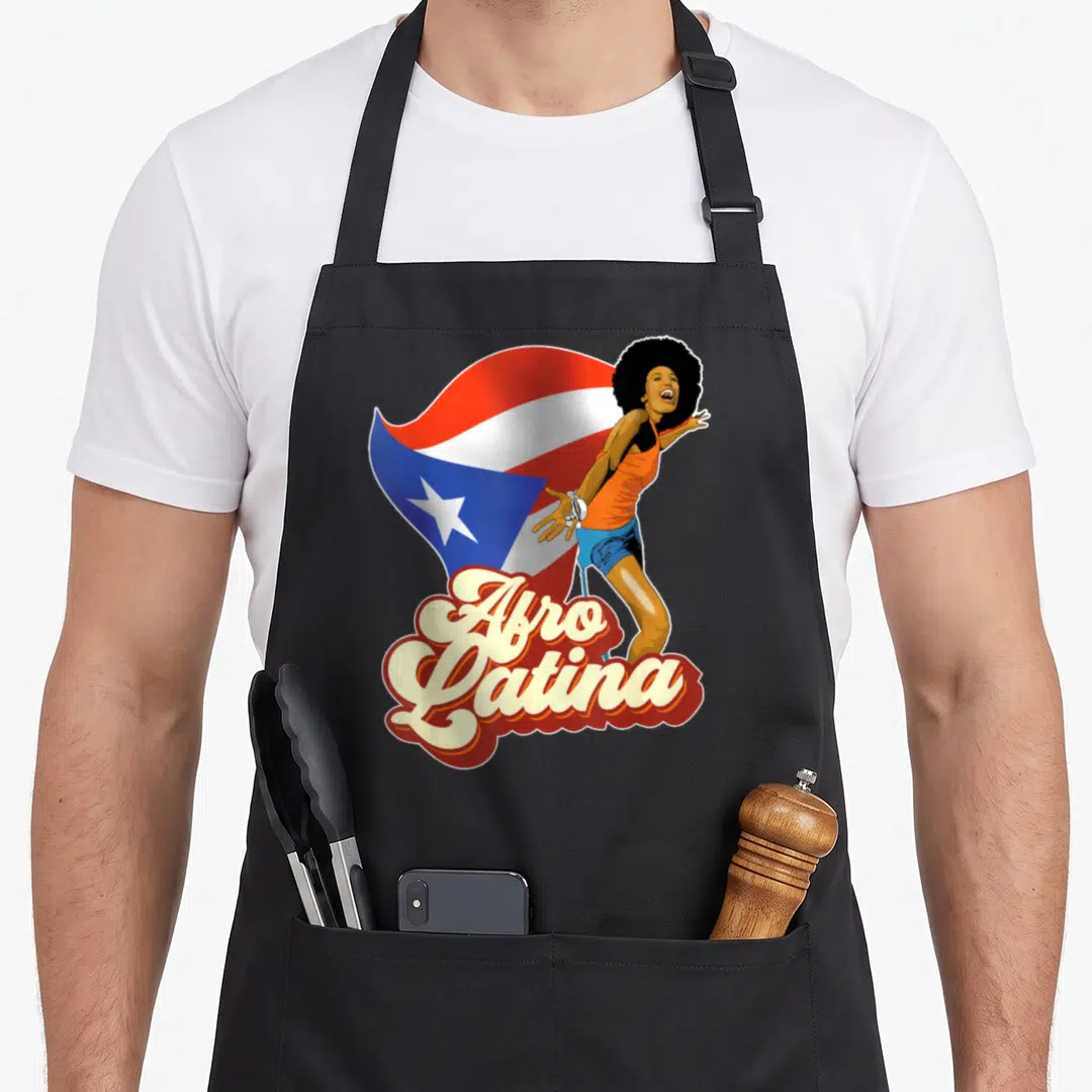 Styleuniversal rican girl apron - Cartoon woman with afro and waving flag with Afro Latina script text — shown on a black cotton canvas apron against a white background