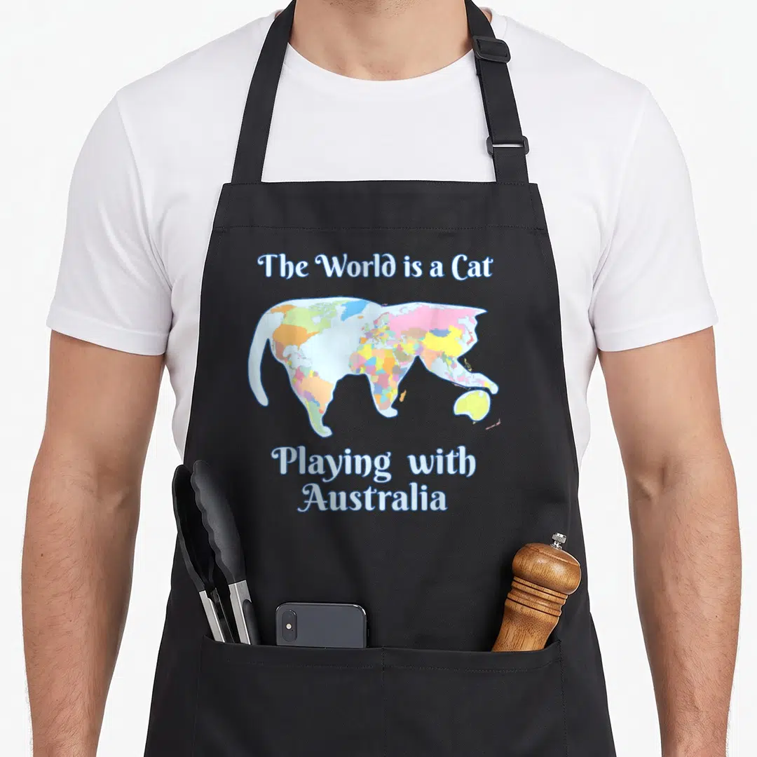 Map cute cat apron - World map shaped like a cat with Australia under paw, blue and yellow text — shown on a black cotton canvas apron against a white background