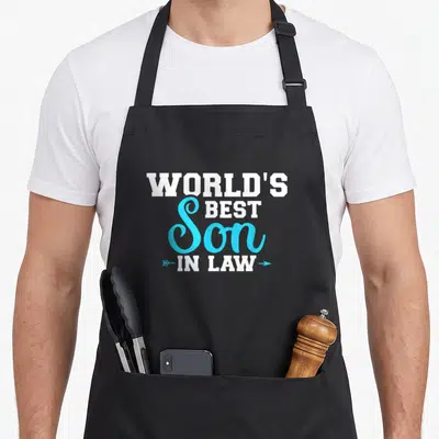 Cute son in law apron - White and blue text reading World's Best Son In Law flanked by two arrows — shown on a black cotton canvas apron against a white background