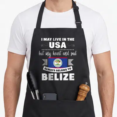 Proud belizean american flag apron - Stacked text around Belize flag with white blue red dots and swirls on black fabric — shown on a black cotton canvas apron against a white background