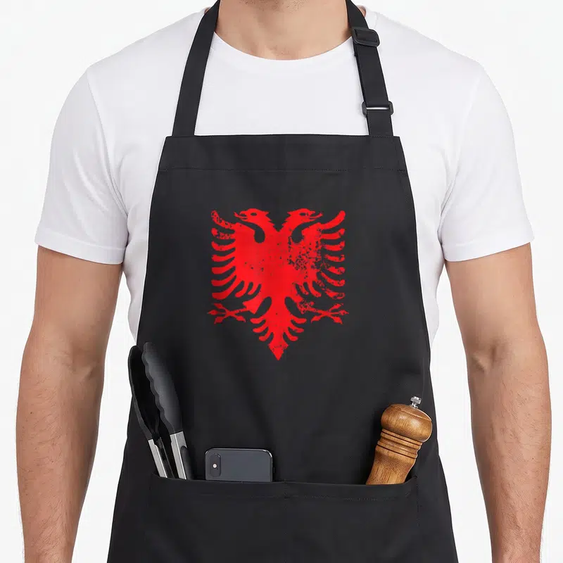 Double eagles apron - Red double-headed eagle with distressed texture centered on black background — shown on a black cotton canvas apron against a white background
