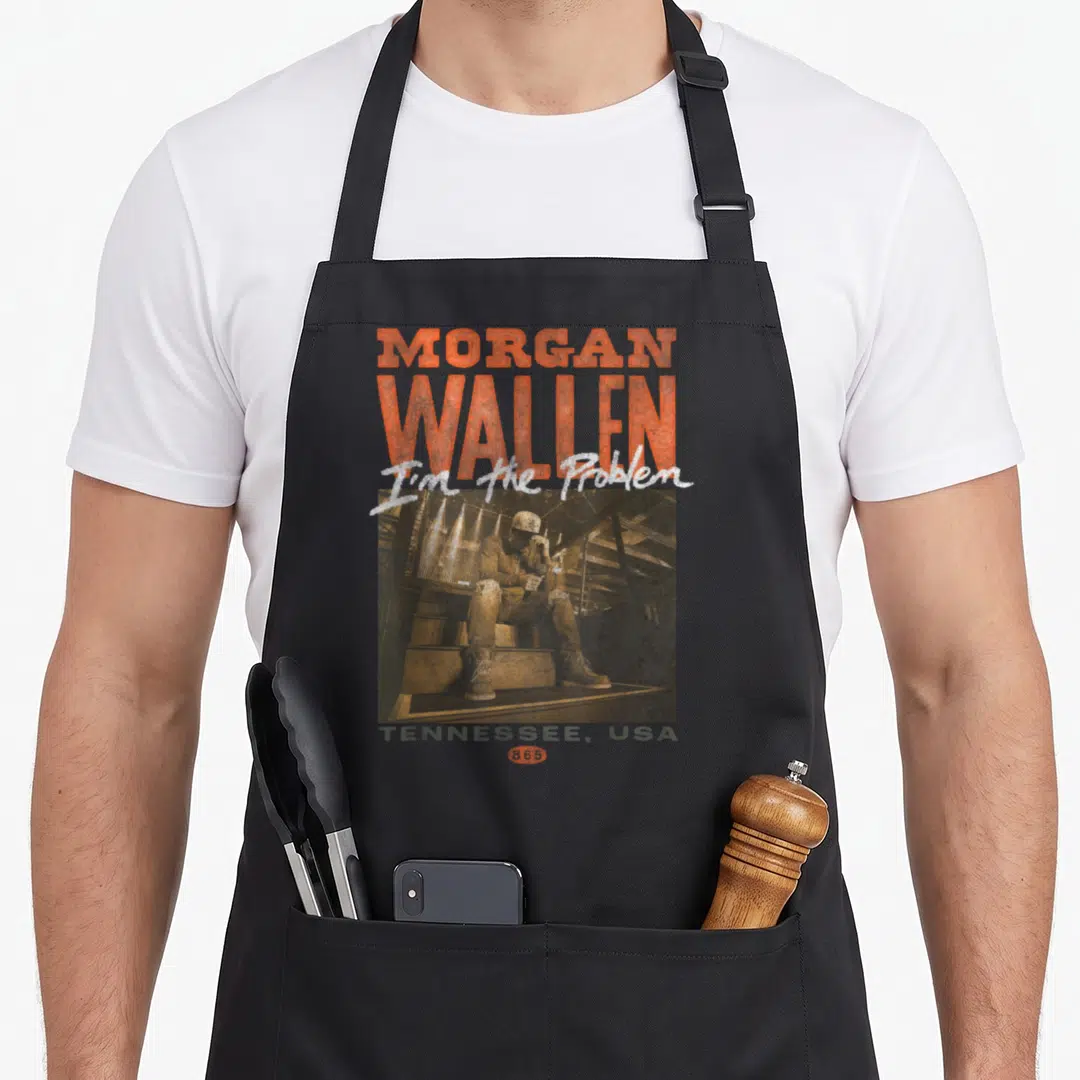 Morgan concert apron - Morgan Wallen text I'm the Problem man sitting stairs Tennessee USA distressed — shown on a black cotton canvas apron against a white background