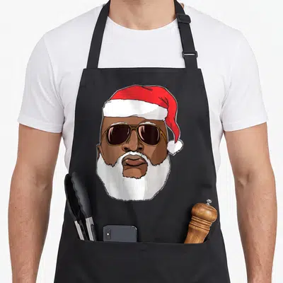 Hop hip apron - Cartoon Black Santa face with sunglasses red hat white beard brown skin — shown on a black cotton canvas apron against a white background