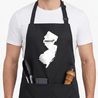 Jersey forever pride apron - White New Jersey map silhouette with grey FOREVER text and small heart inside — shown on a black cotton canvas apron against a white background
